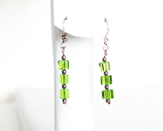 copper and green glass cubes beaded earrings on a white background