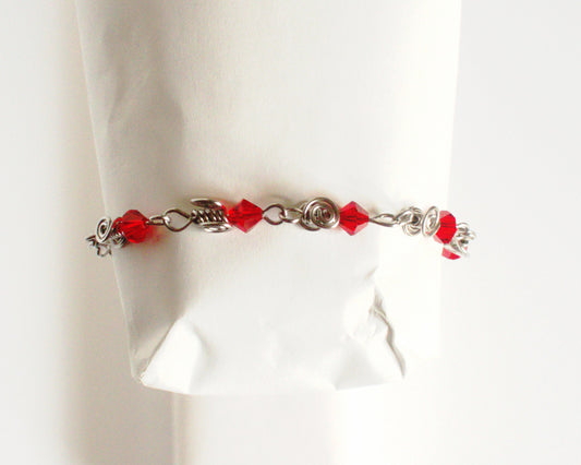 Stainless Steel Bracelet with red beads on a white background