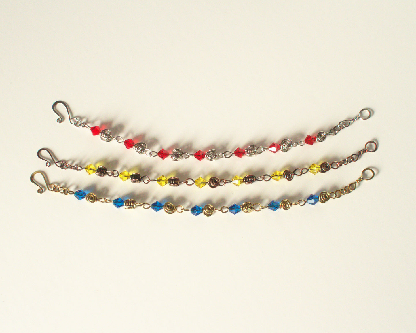 Three beaded bracelets with colorful beads on a white background - showing that other colours and styles are available