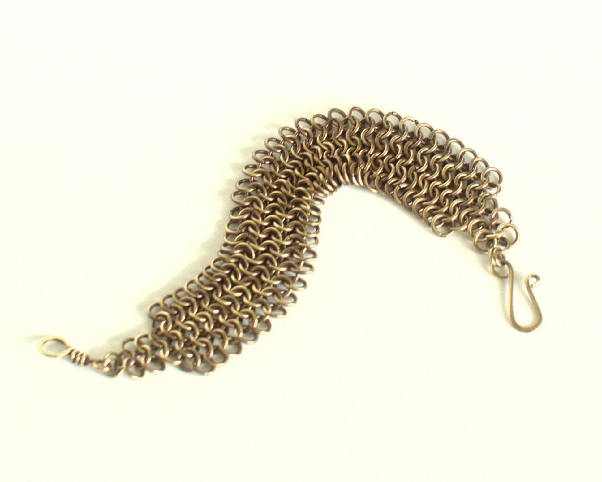 Brass chain bracelet on a white background