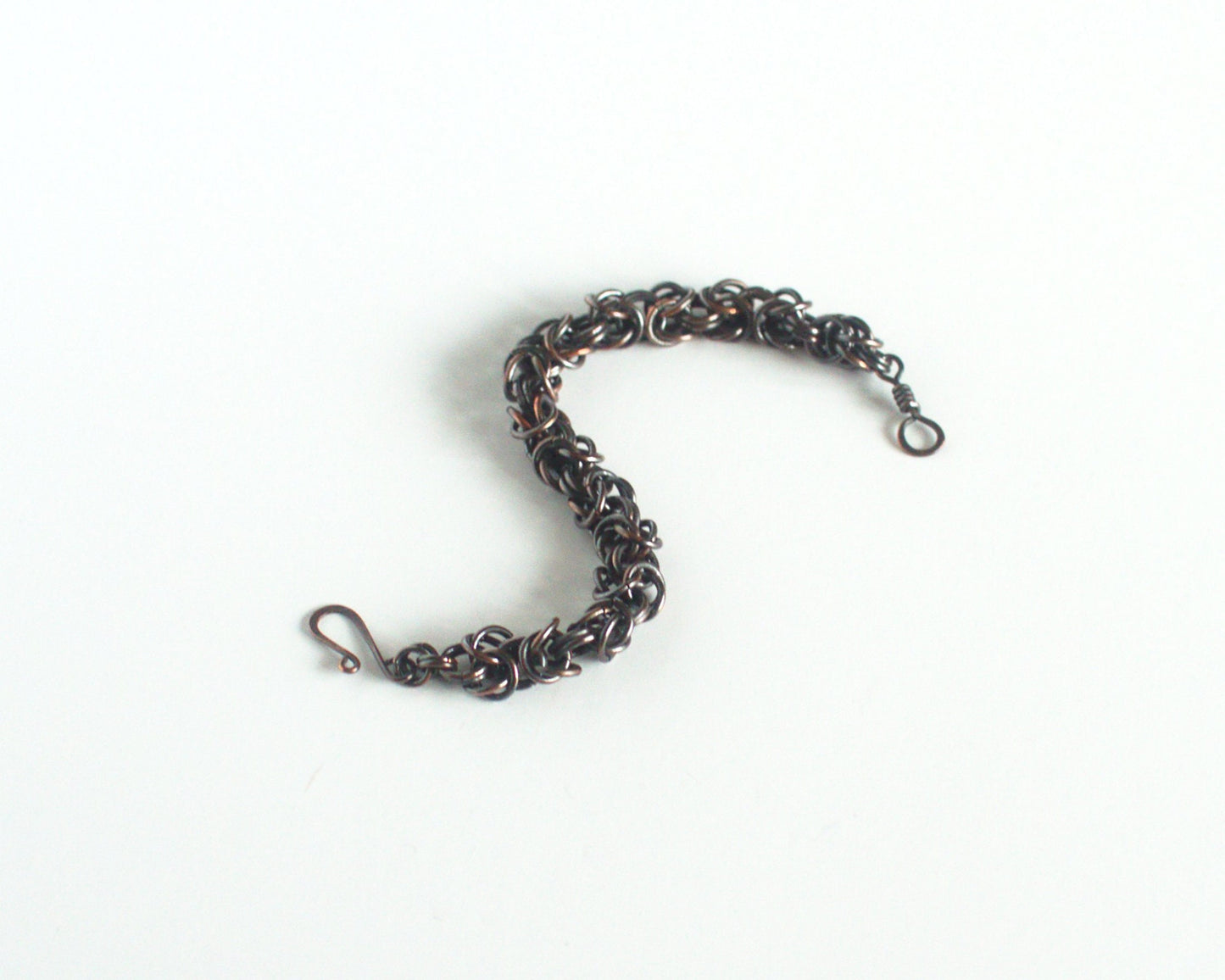 Copper chain bracelet on a white background