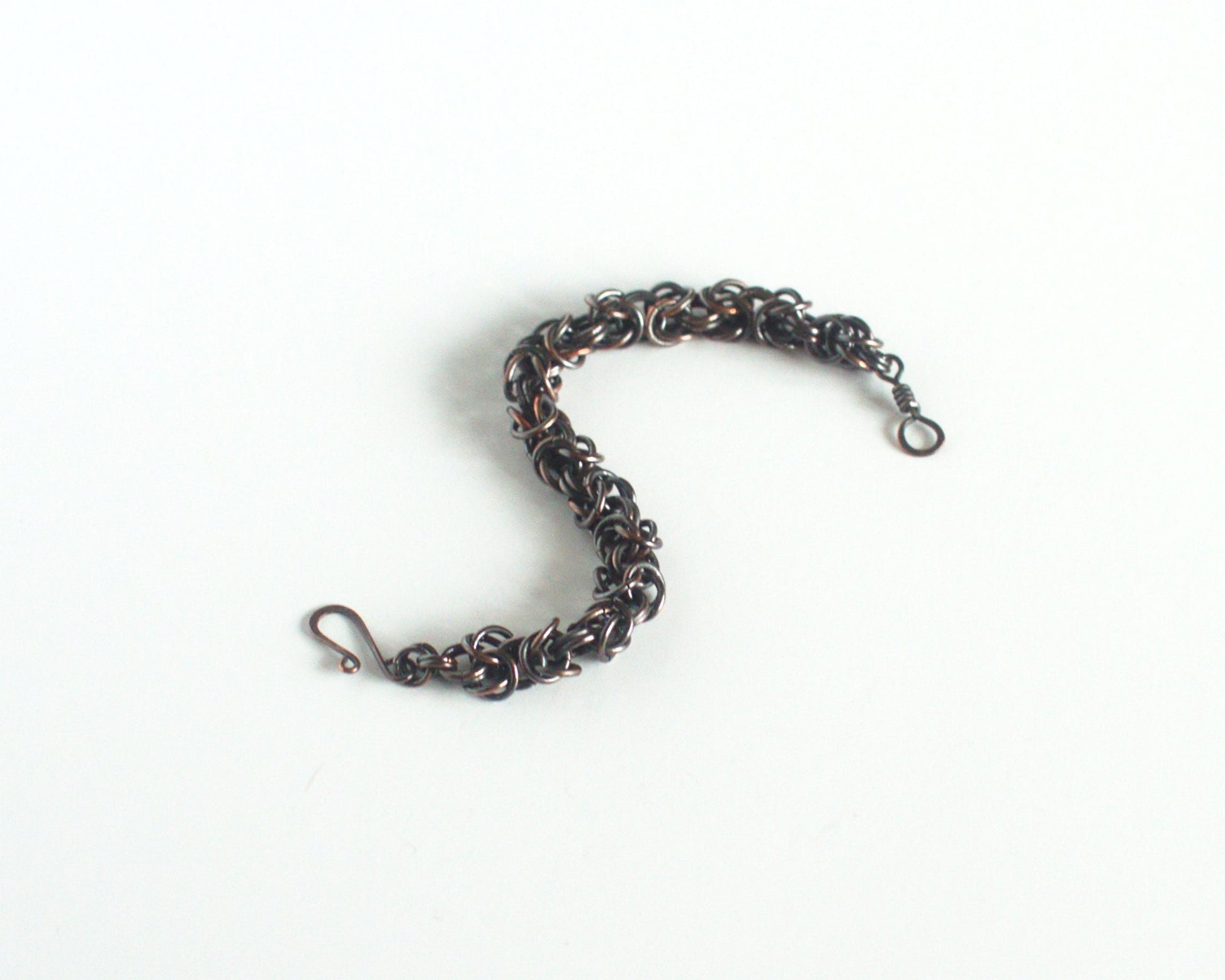 Copper chain bracelet on a white background