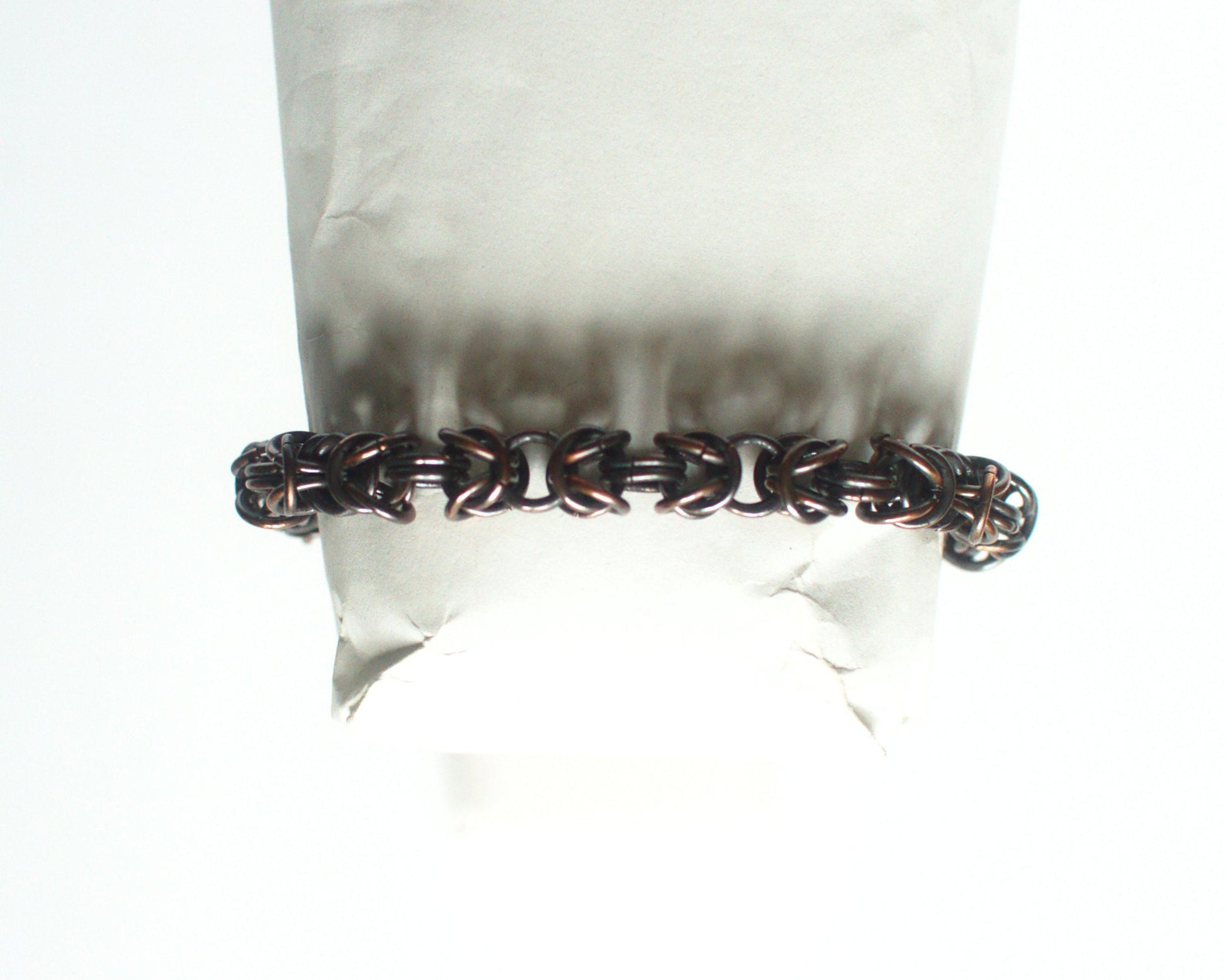 Copper chain bracelet on a white background