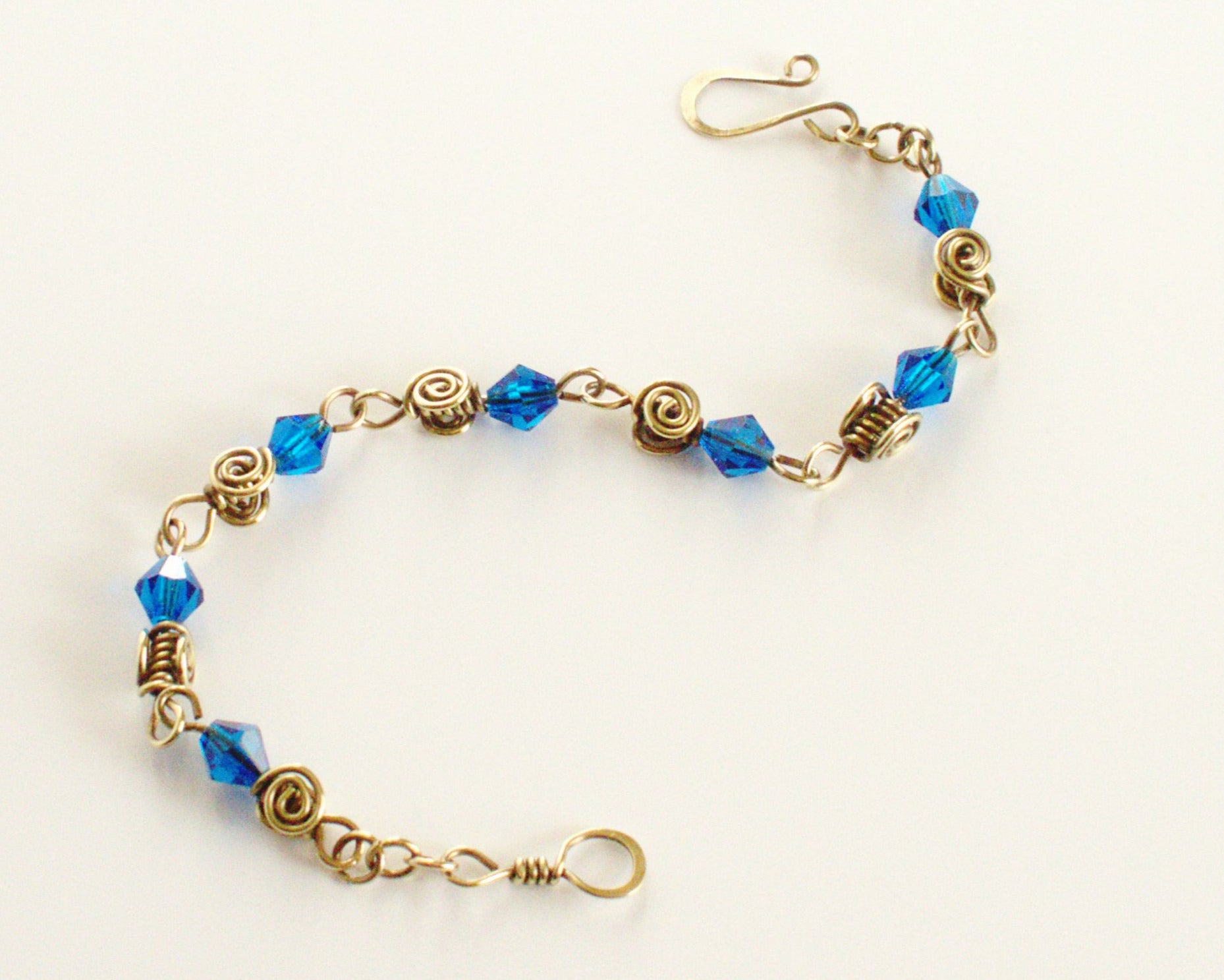 Bracelet with blue beads and gold accents on a white background
