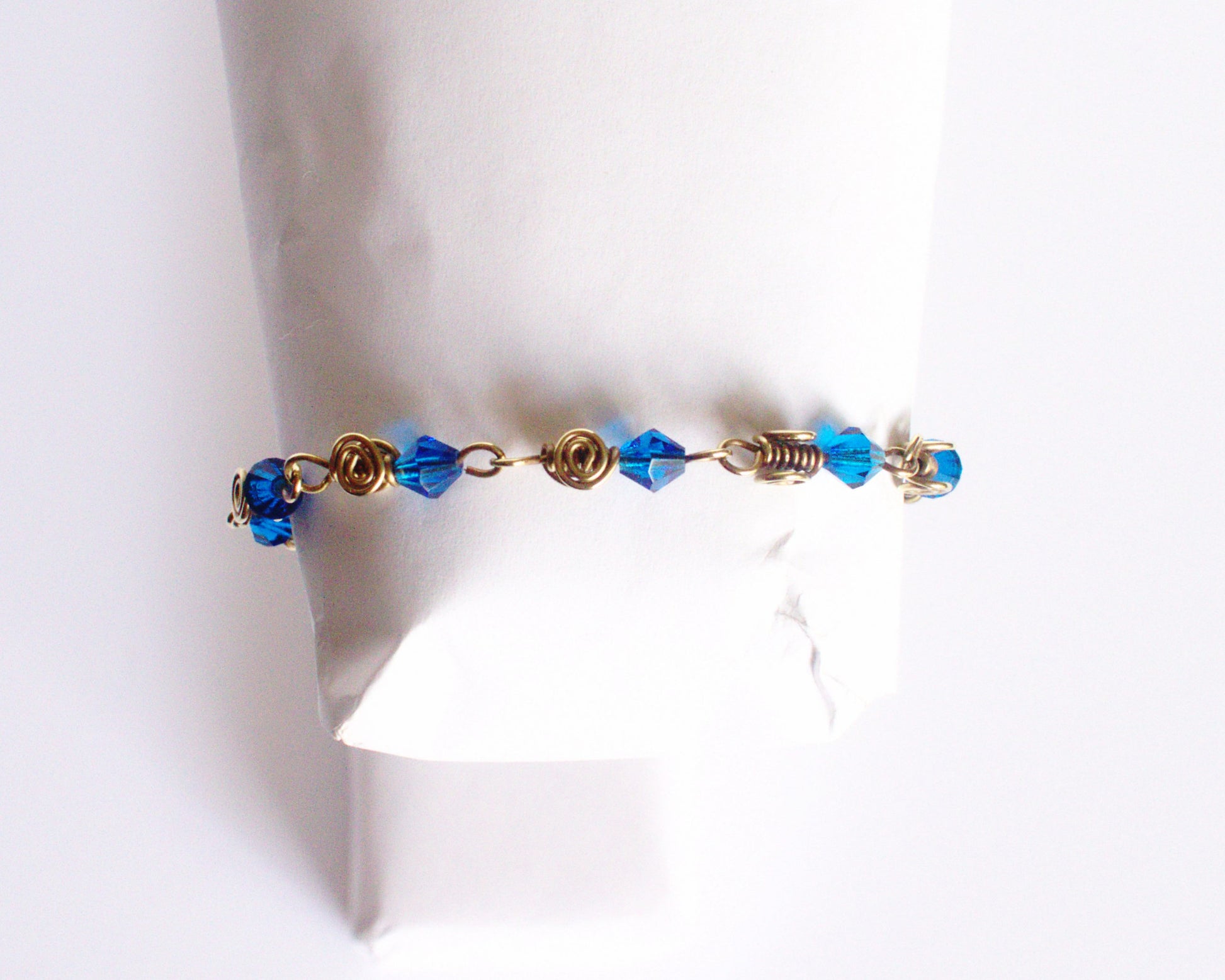 Bracelet with blue beads on a white background