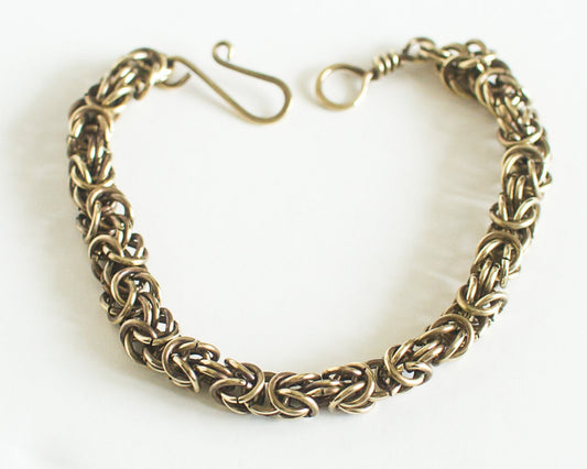 Brass chain bracelet on a white background