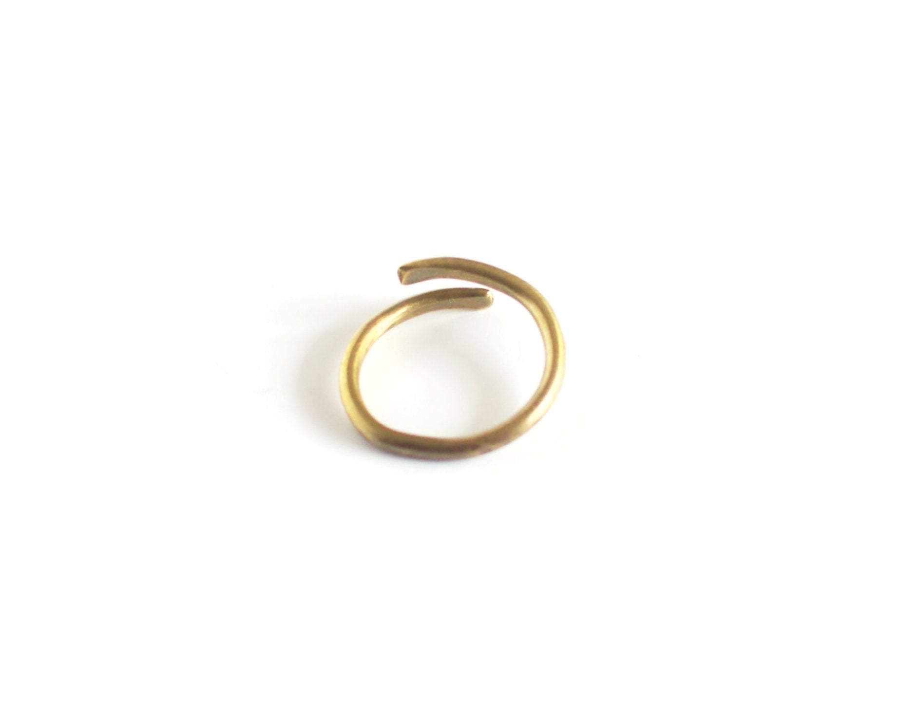Brass open ring on a white background showing the inside surface