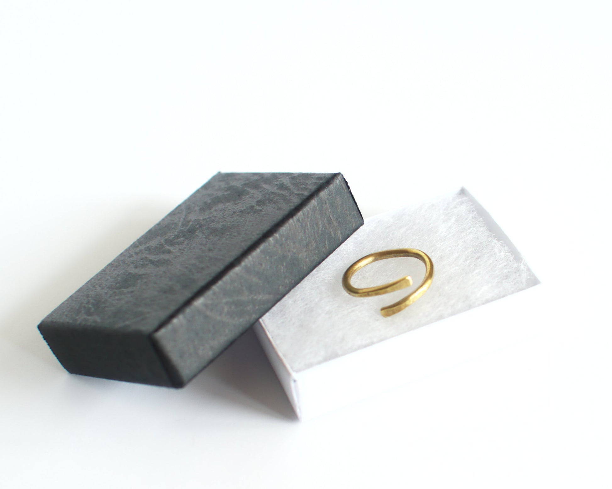 Brass ring in a Black jewelry box on a white background