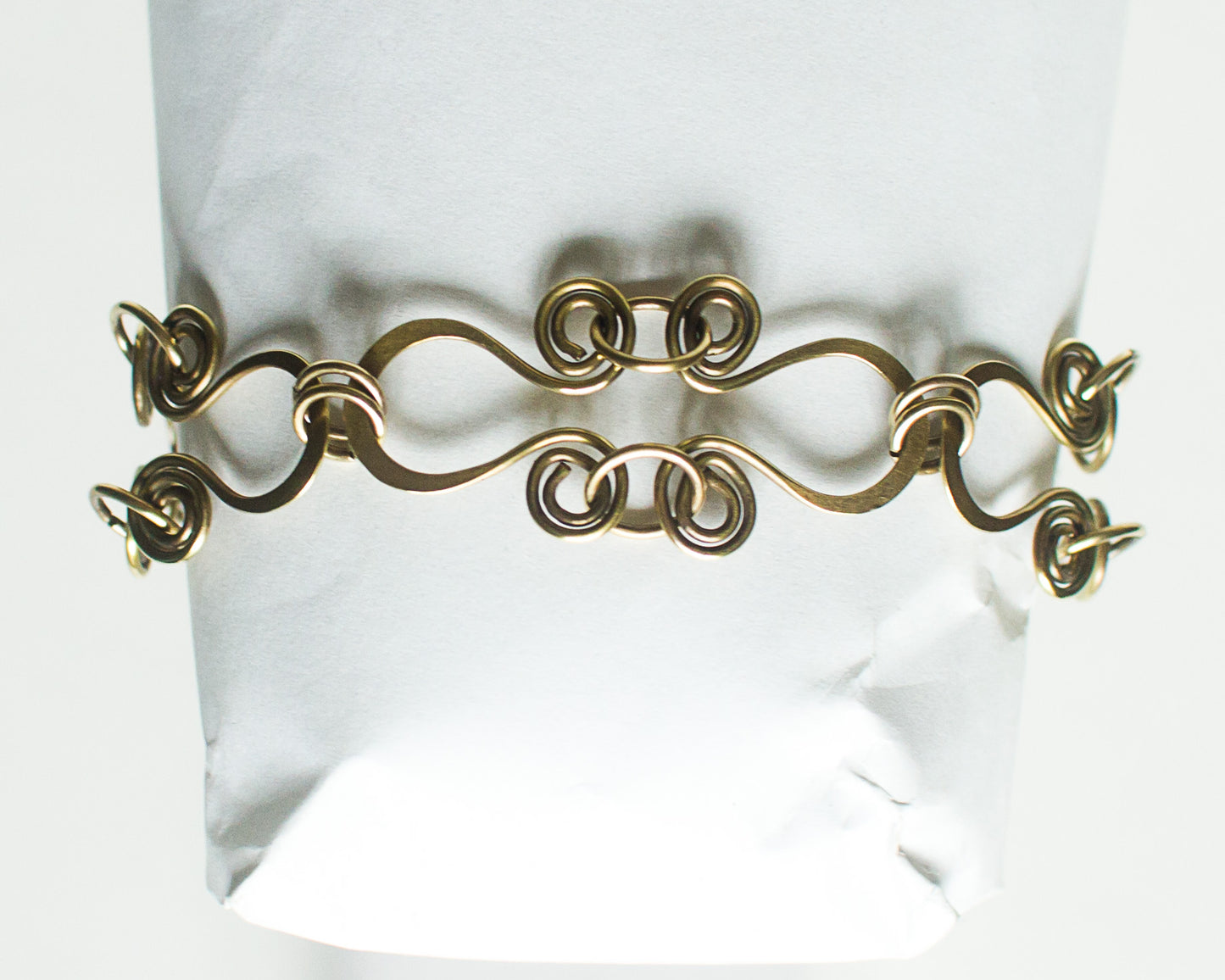 Brass decorative bracelet on a white background