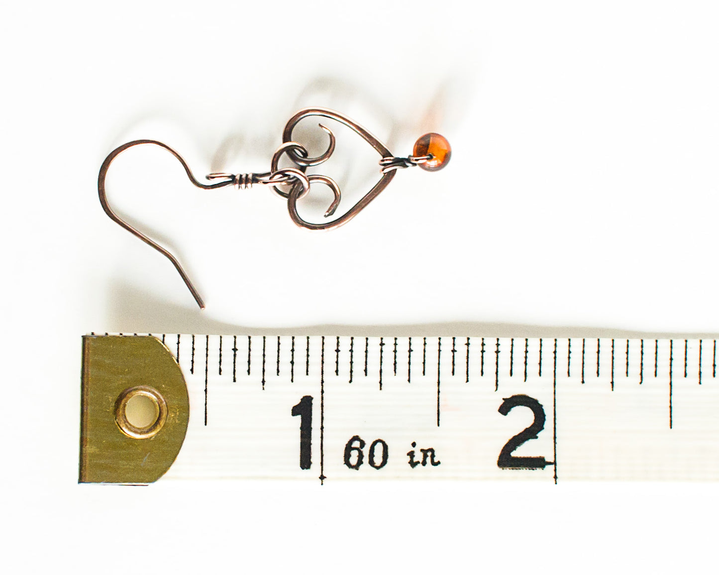 Small earring with a heart design and a bead, measured against a ruler on a white background - the length shown is 1 5/8 inches or 4.1cm.