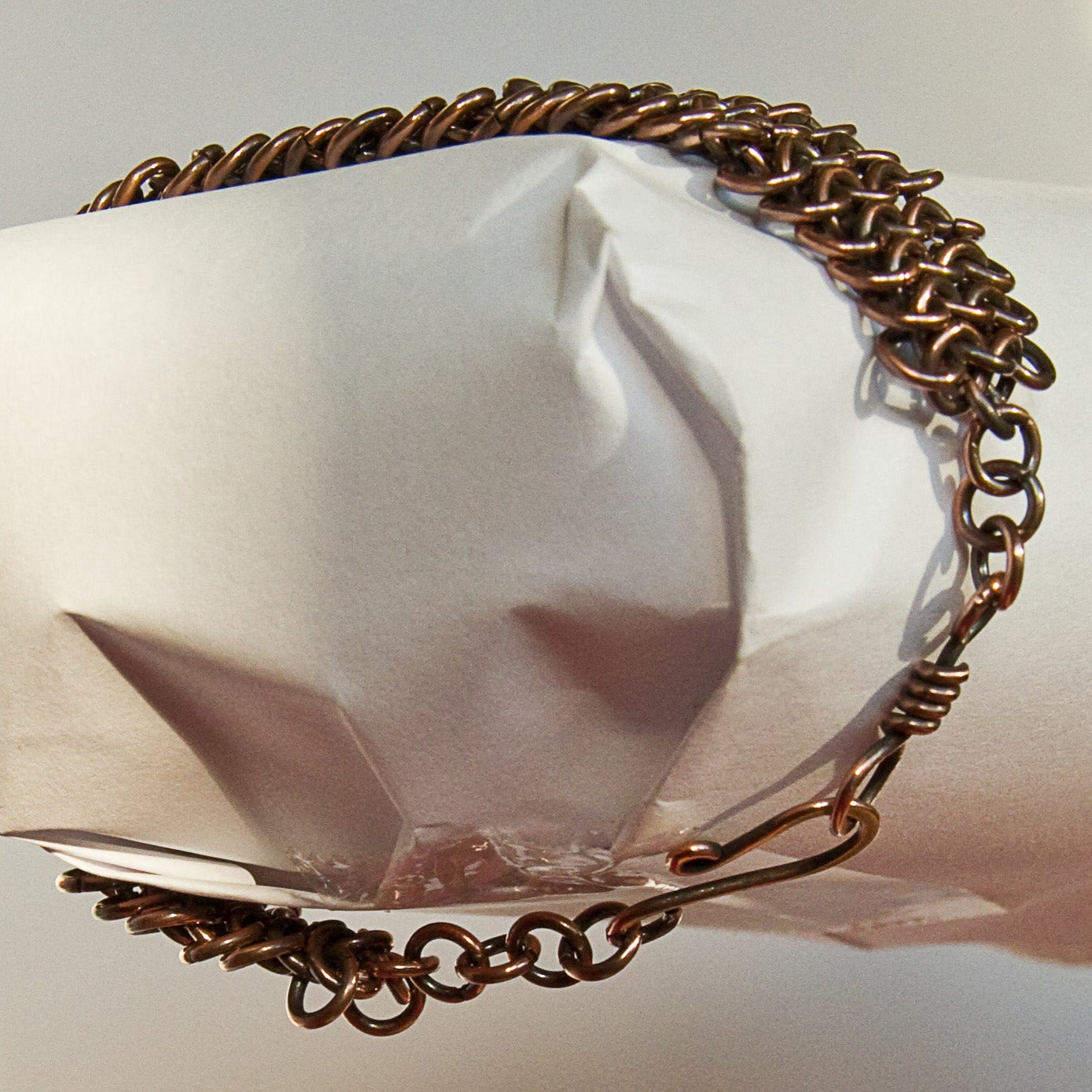 Copper chain bracelet on a white background