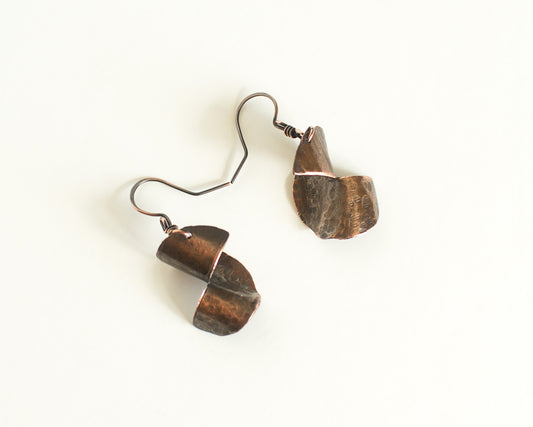 Copper Earrings with a 3 dimensional form, copper ear-wires on a white background