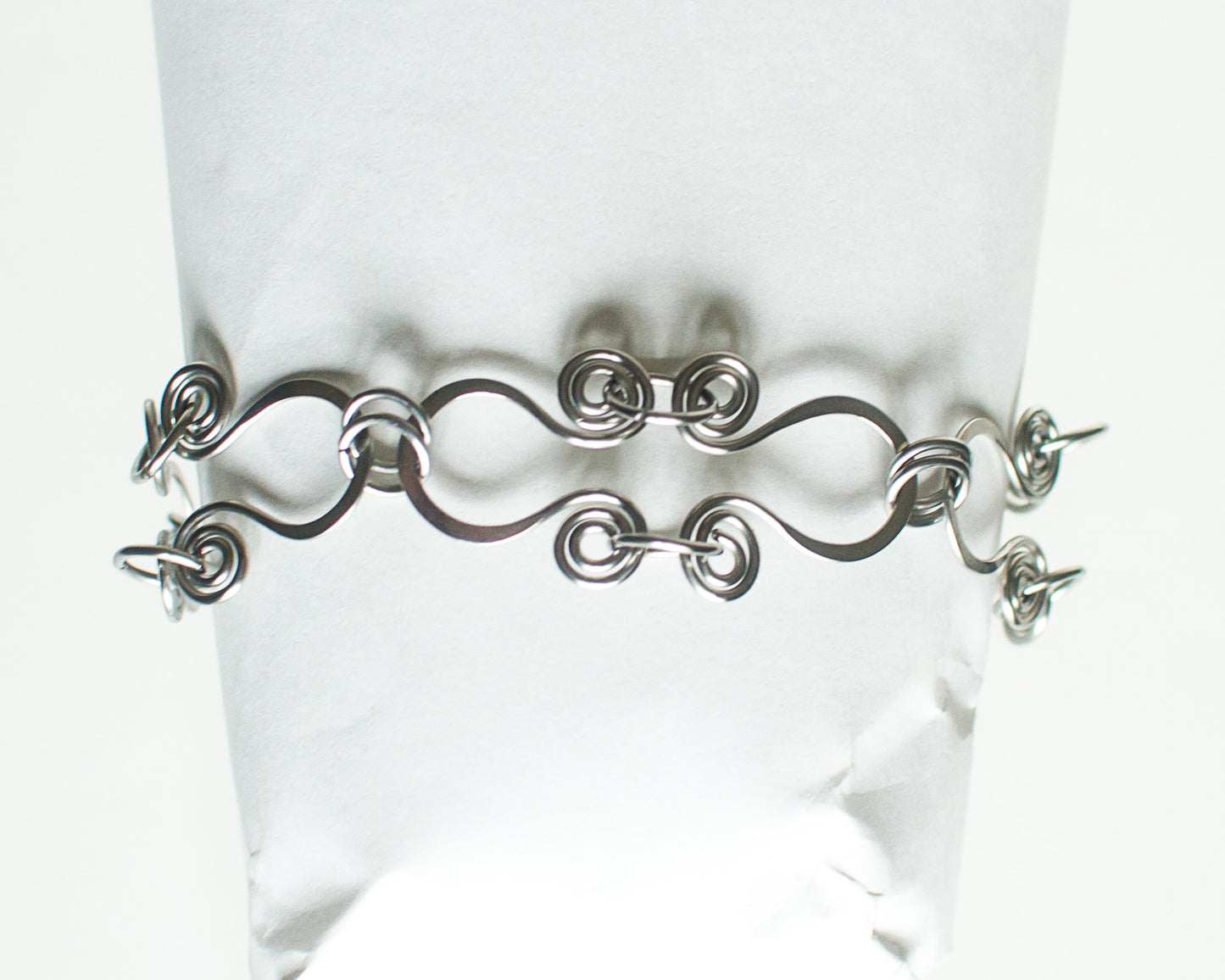 Stainless steel bracelet on a mannequin against a white background