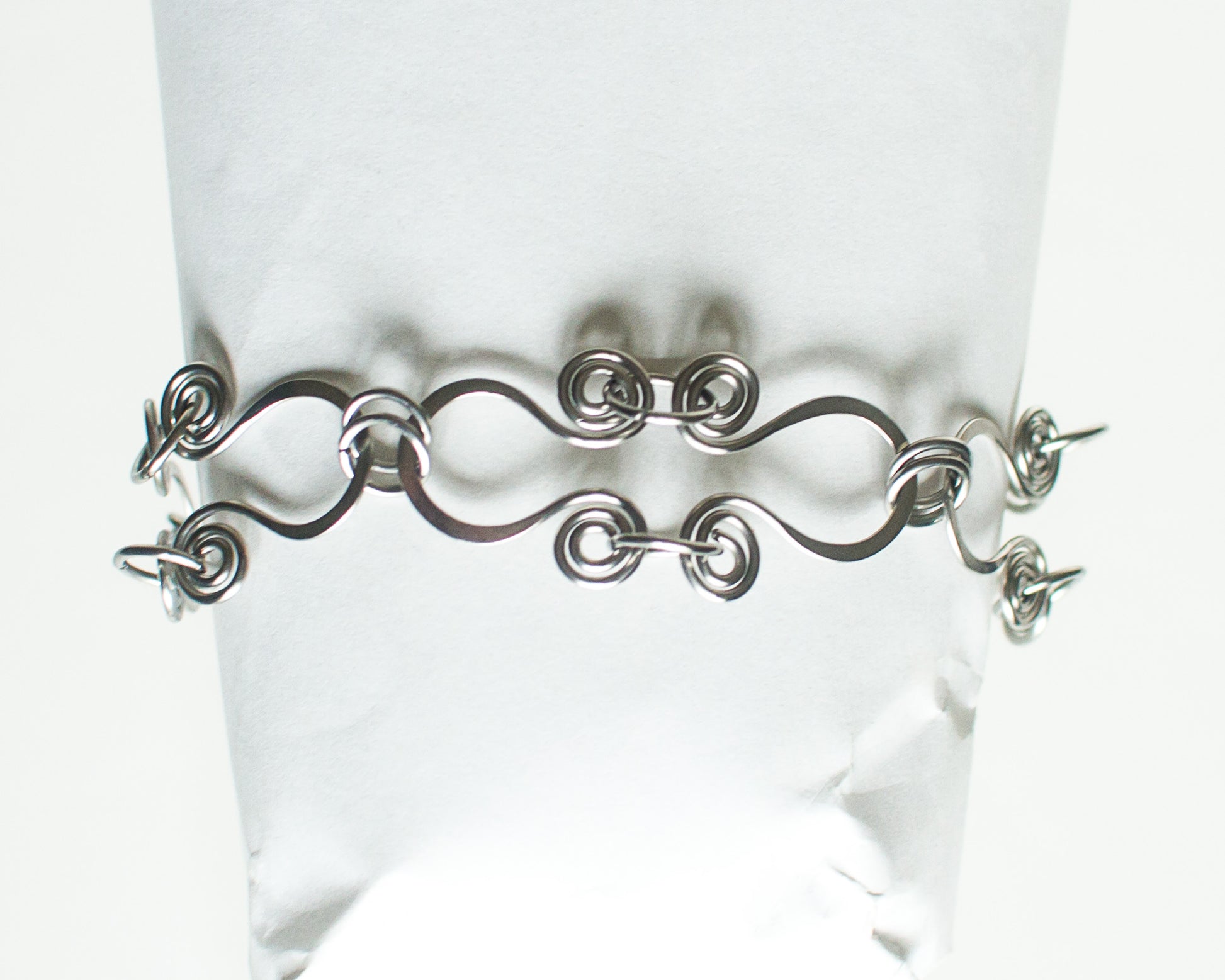 Stainless steel bracelet on a mannequin against a white background