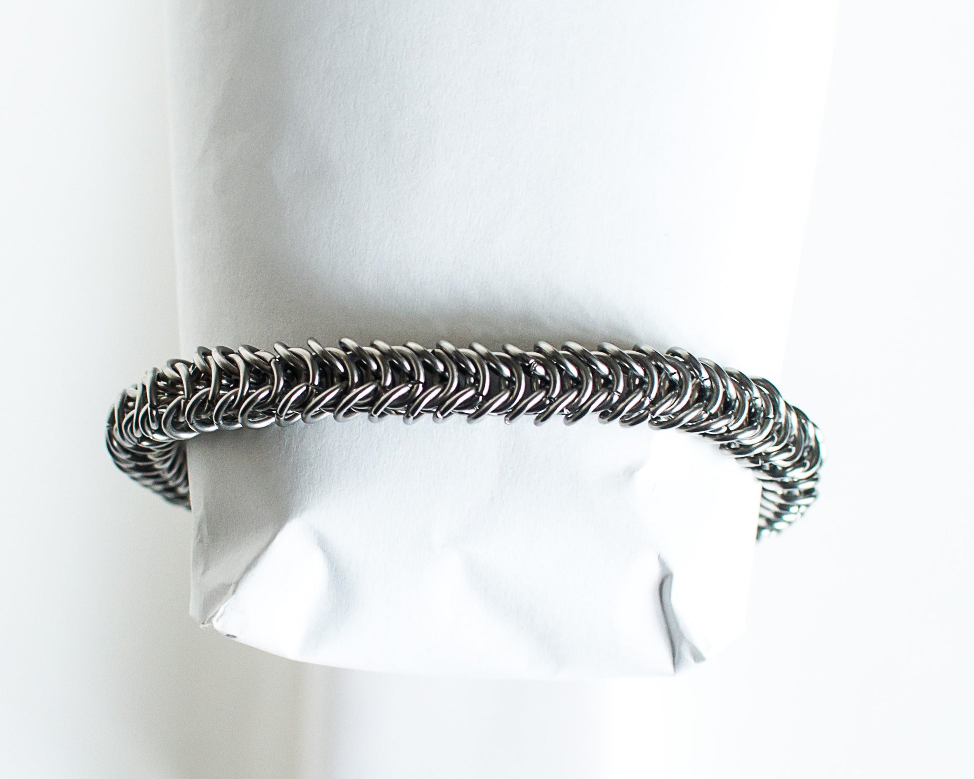 Steel chainmaille bracelet on a white background