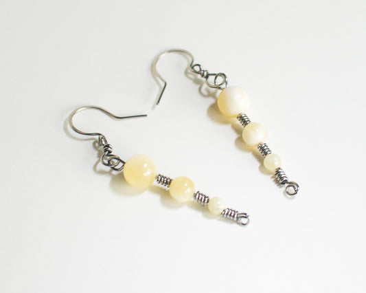 Pair of honey quartz stainless steel earrings on a white background