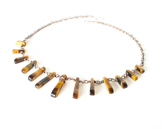 Necklace with tiger eye stones on a white background