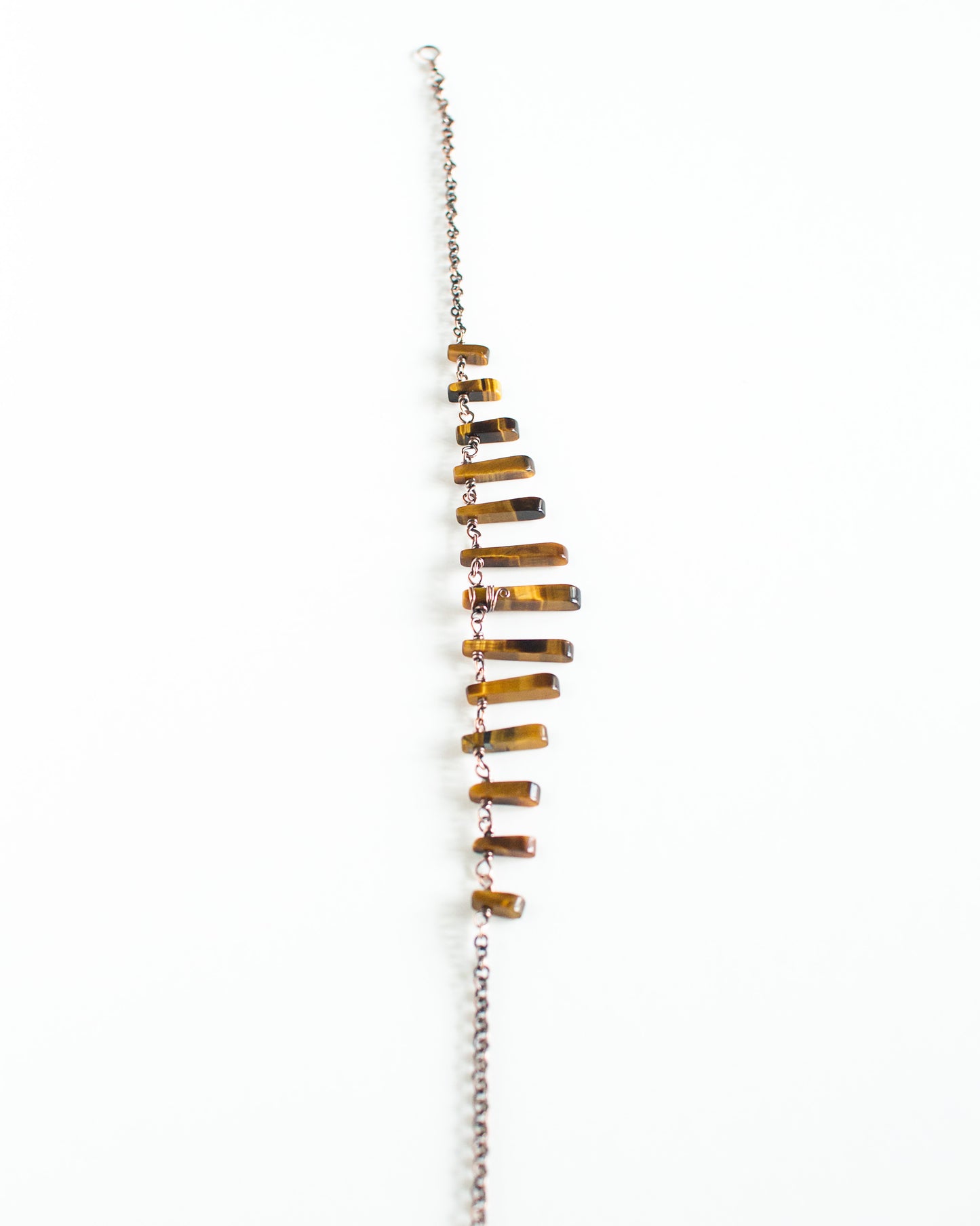 Necklace with tiger's eye stones on a white background