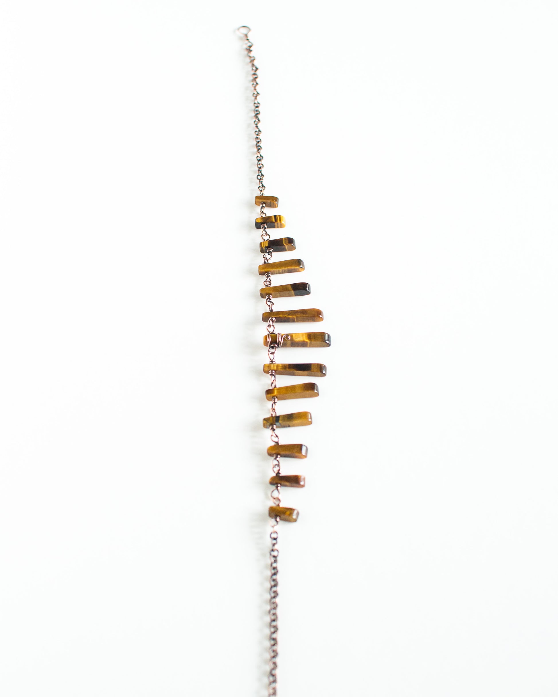 Necklace with tiger's eye stones on a white background