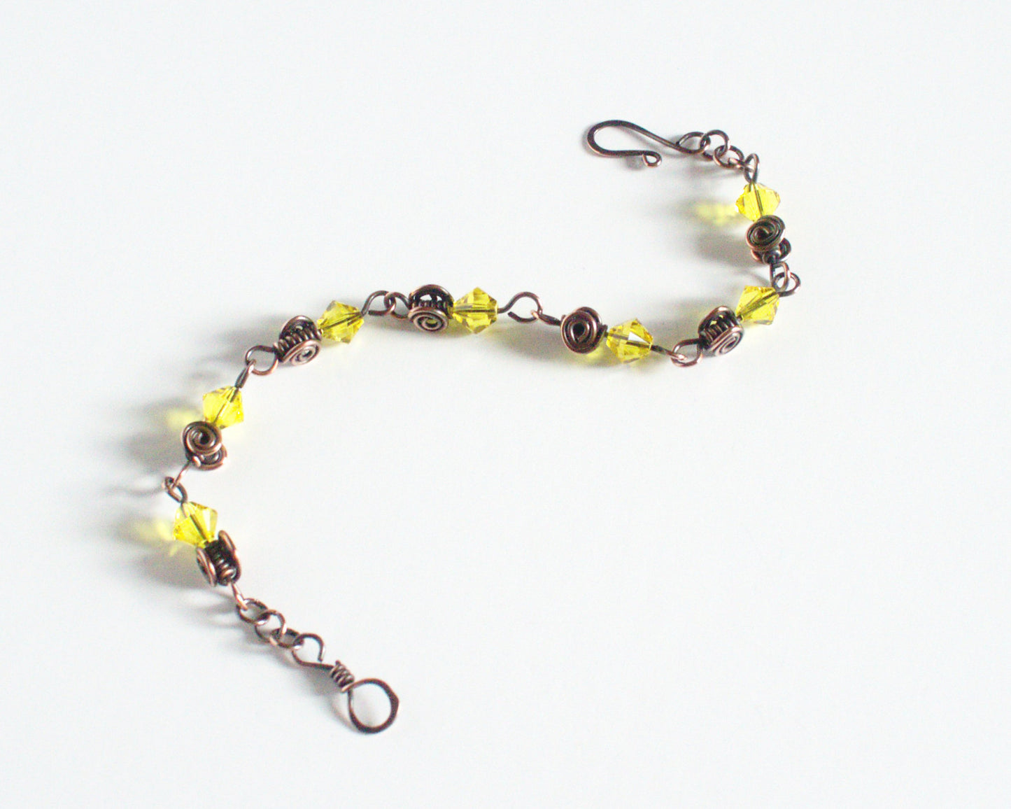 Copper Bracelet with yellow beads and a clasp on a white background