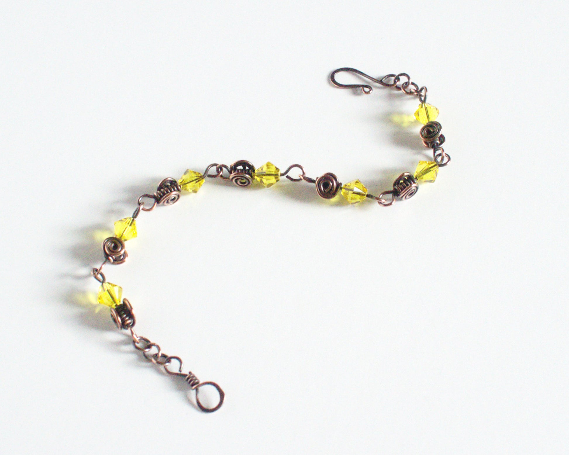 Copper Bracelet with yellow beads and a clasp on a white background