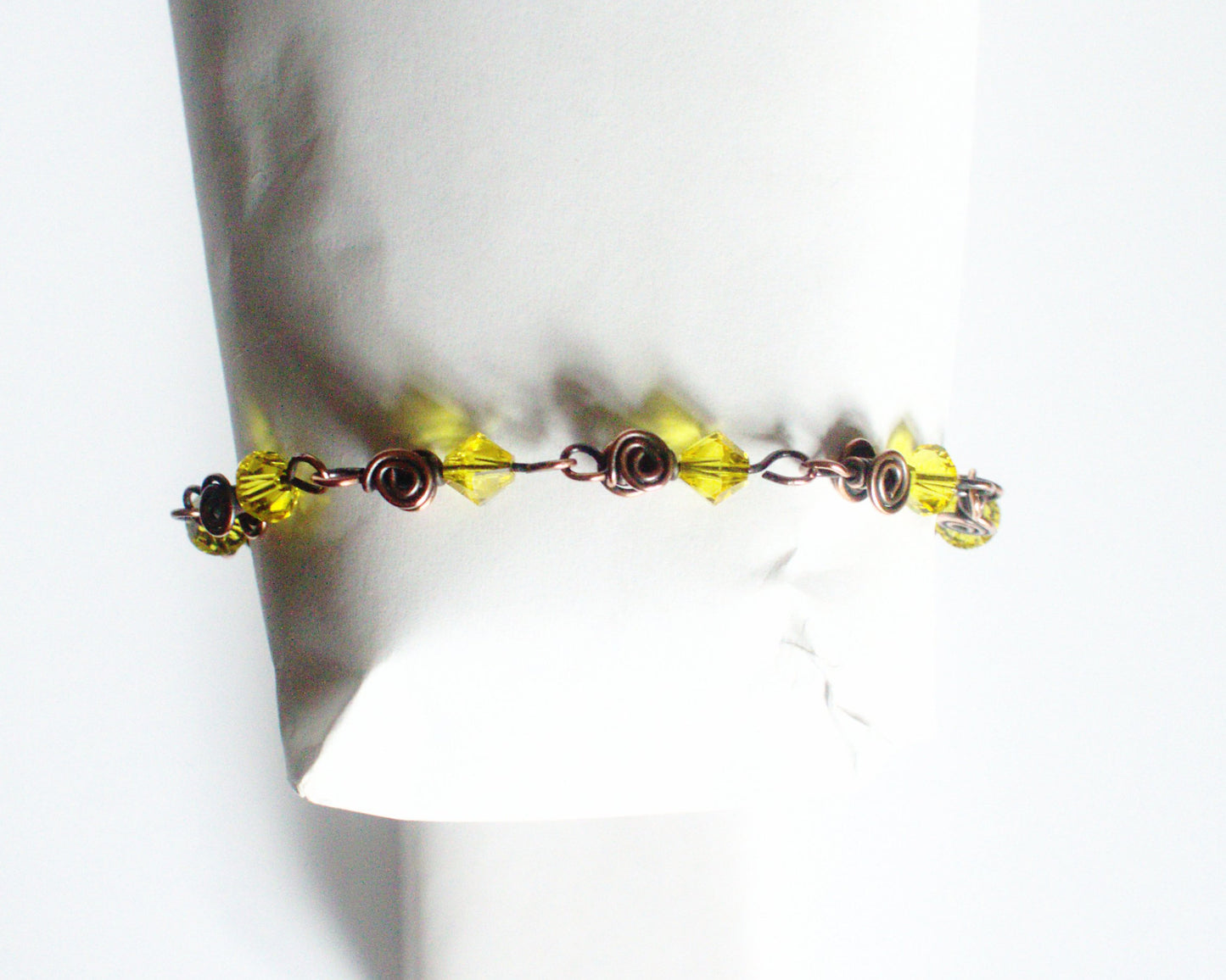 Copper Bracelet with yellow beads on a white background