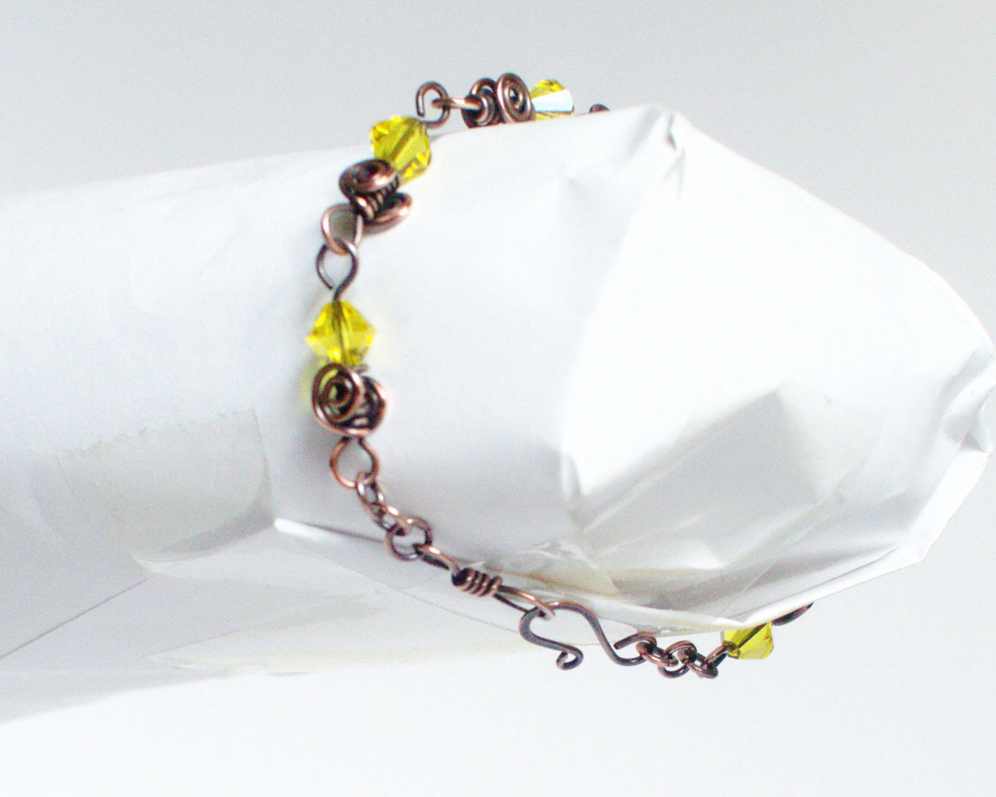 Copper Bracelet with yellow beads on a white background