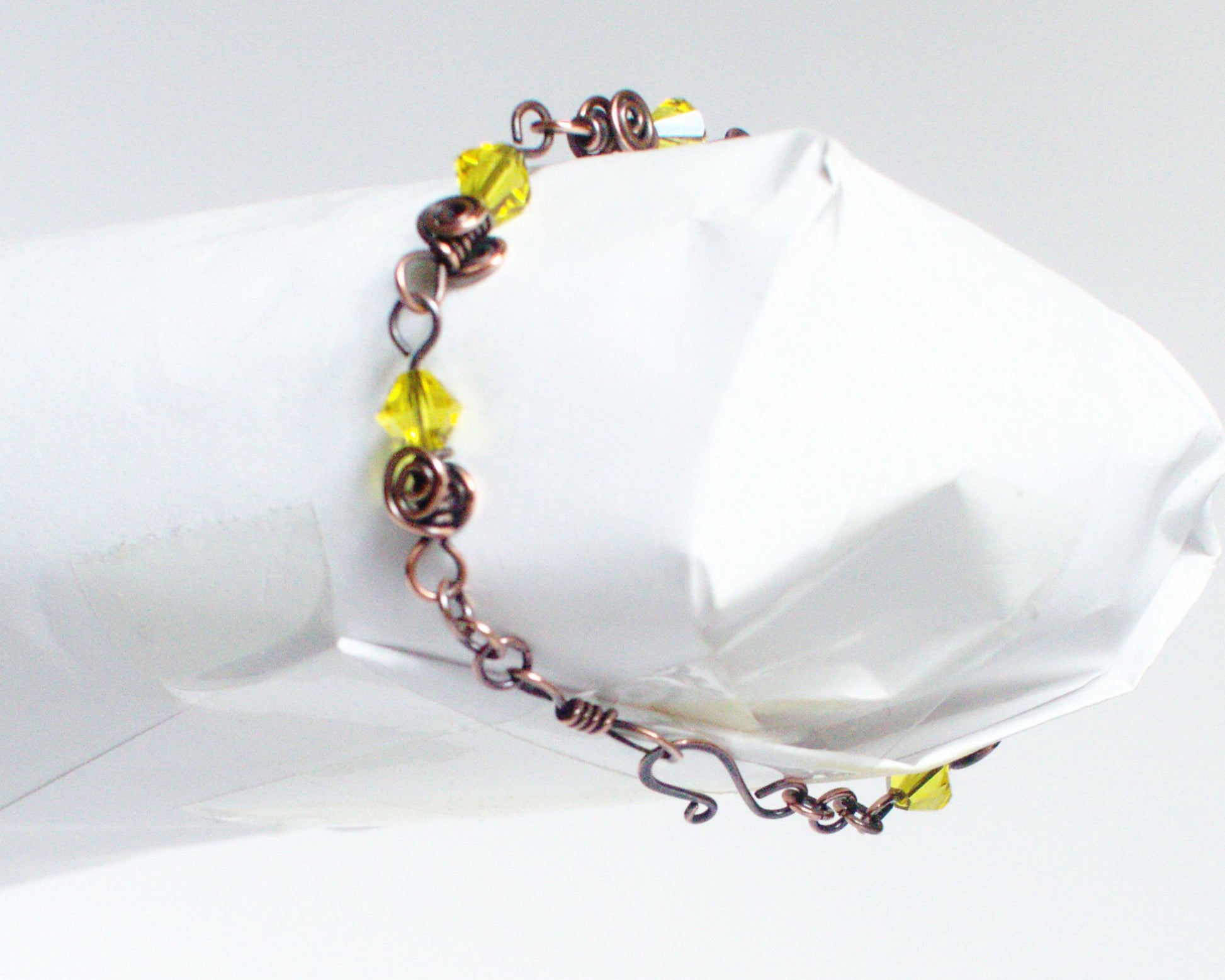 Copper Bracelet with yellow beads on a white background