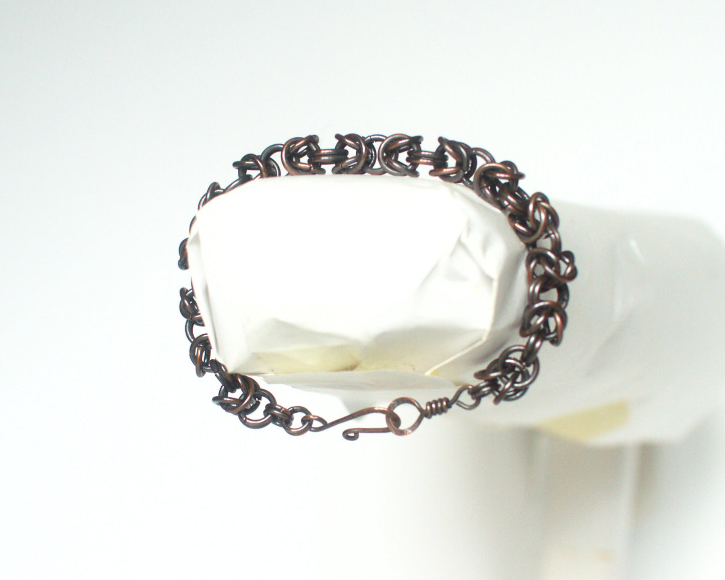 Copper byzantine chain bracelet on a white background