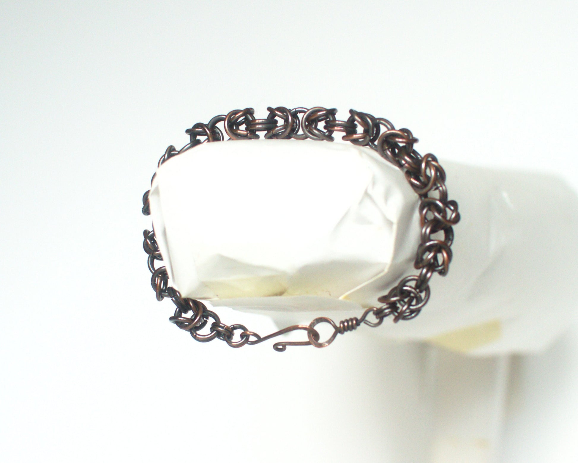 Copper byzantine chain bracelet on a white background